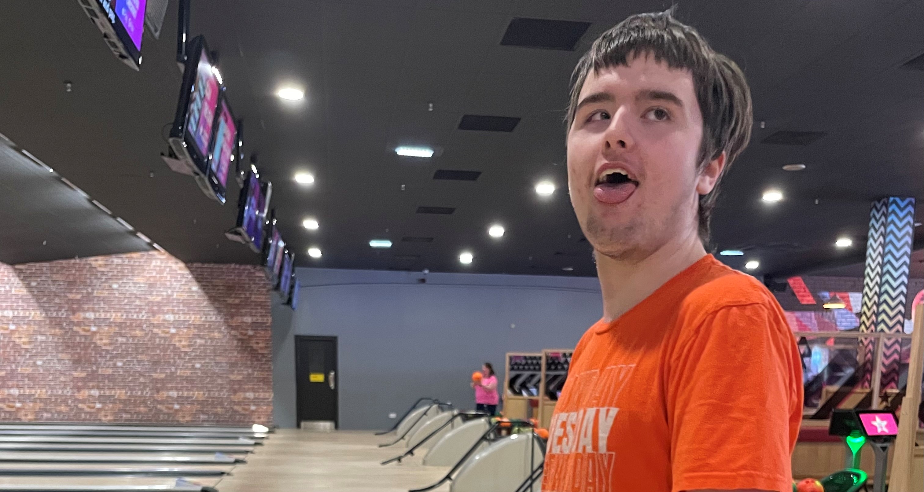 A young man at a bowling alley