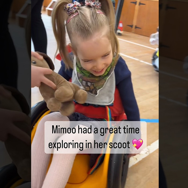 A little girl at the play centre sits in her Scooot sit and ride.