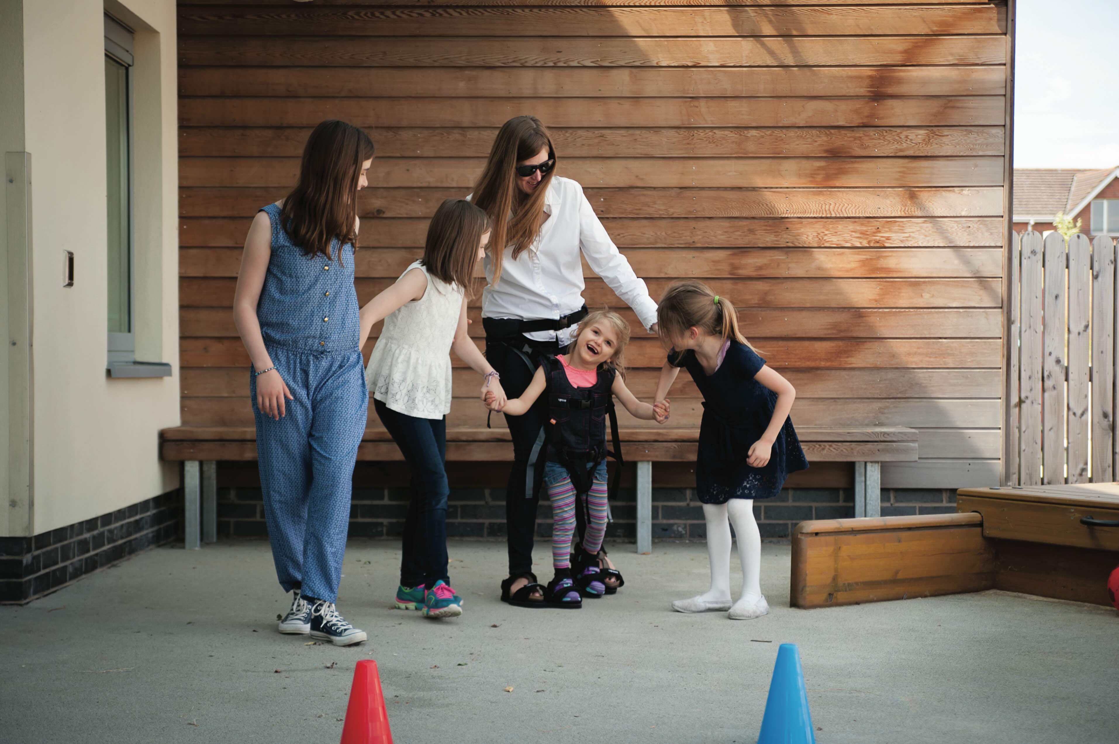 Image of child using the Upsee to play with family.