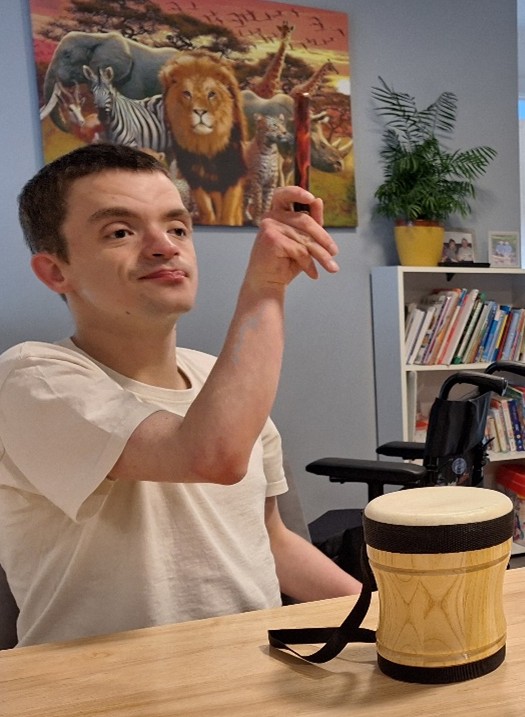 A young man plays the drum set