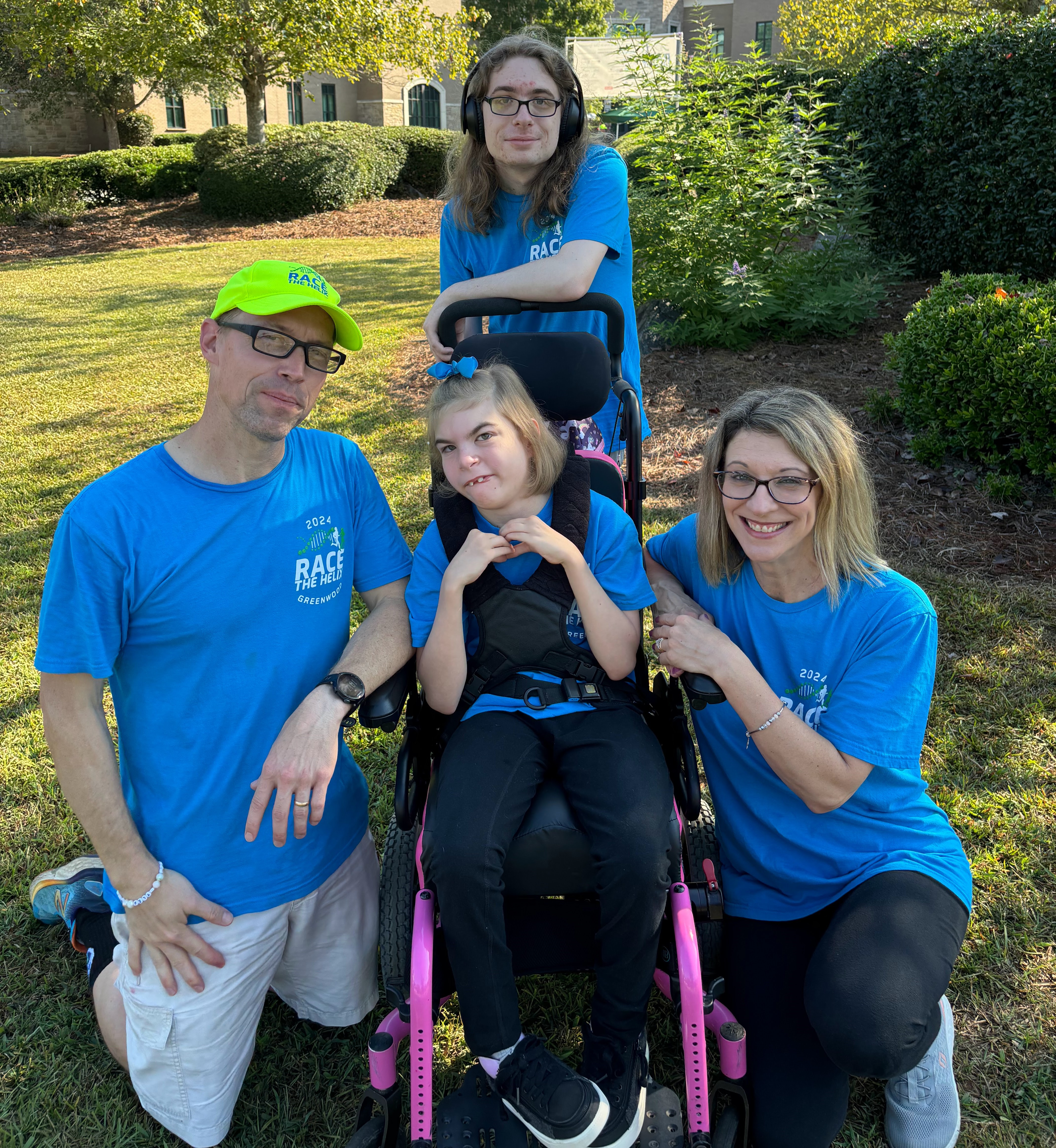 A family of 4 smile at the camera