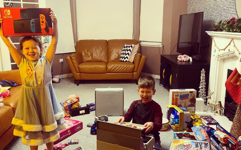 Two children with their Christmas presents