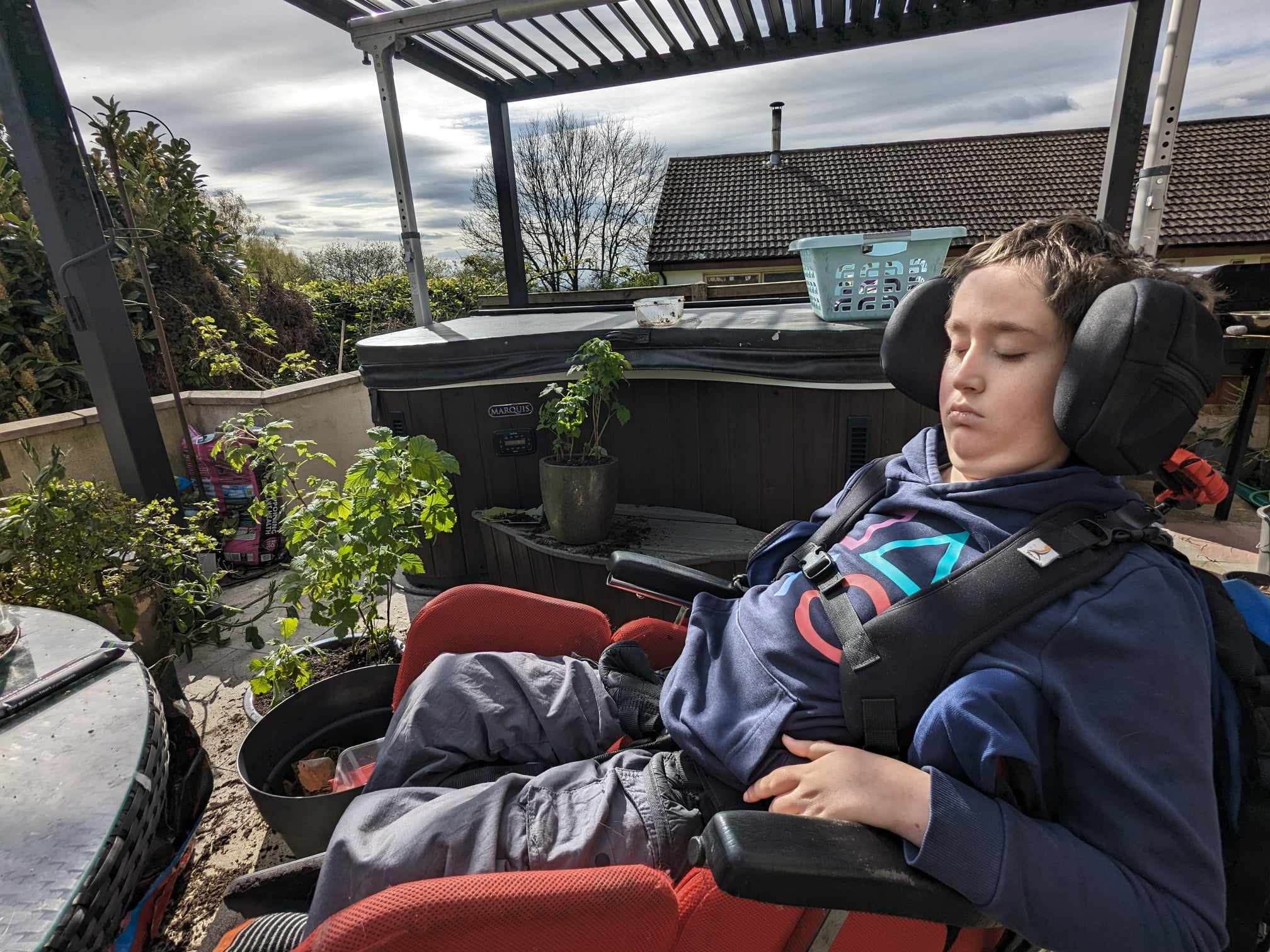 A young boy sits in an adapted seat