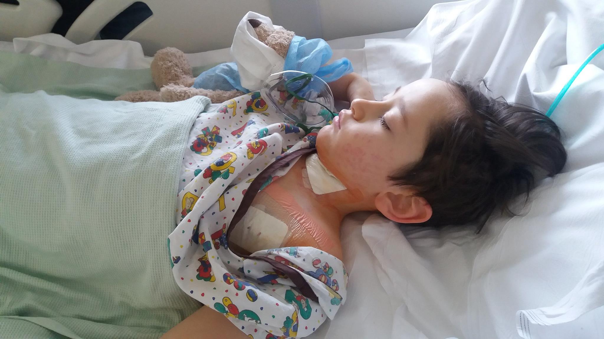 A young man recovering in a hospital bed post surgery