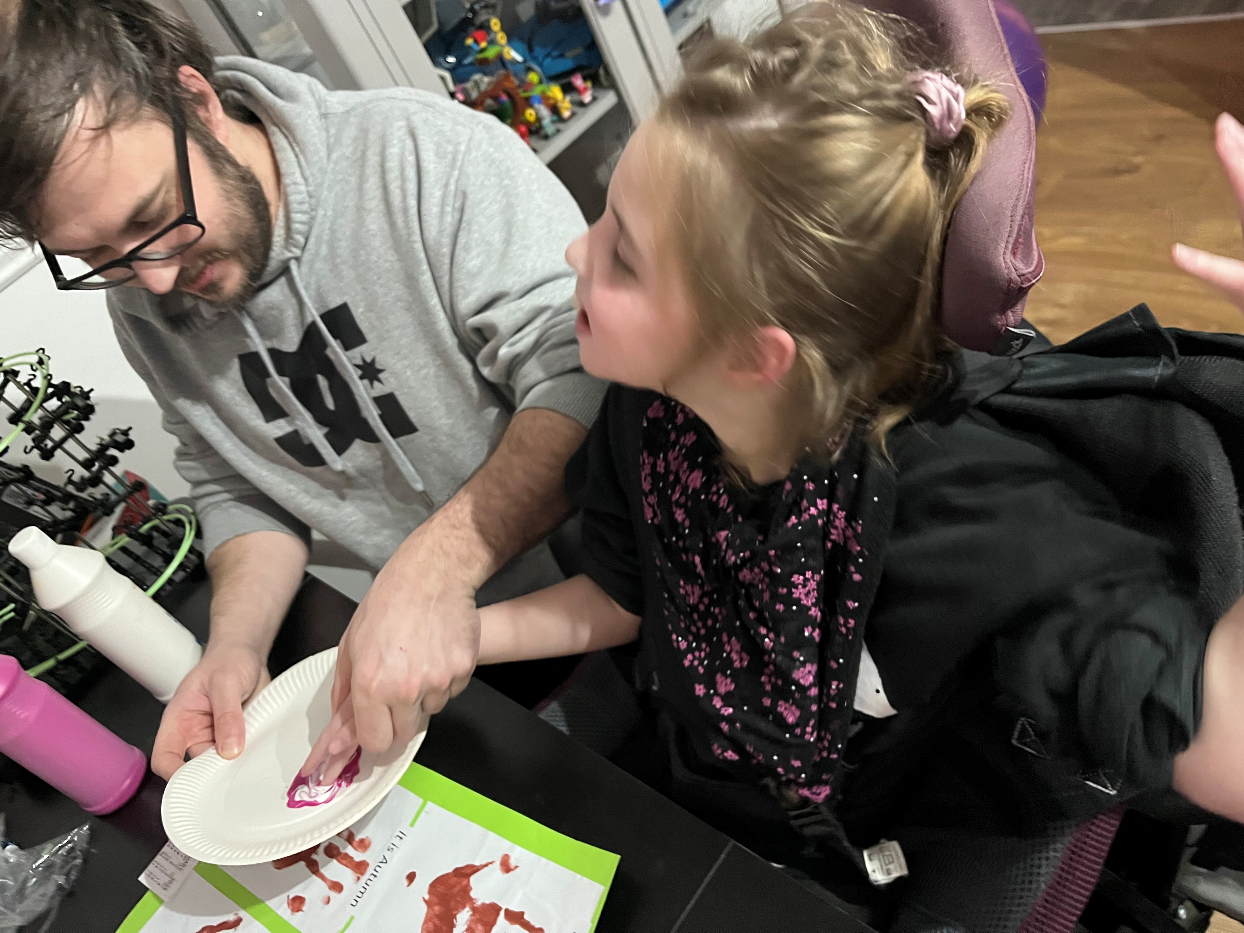 A little girl enjoys some painting.