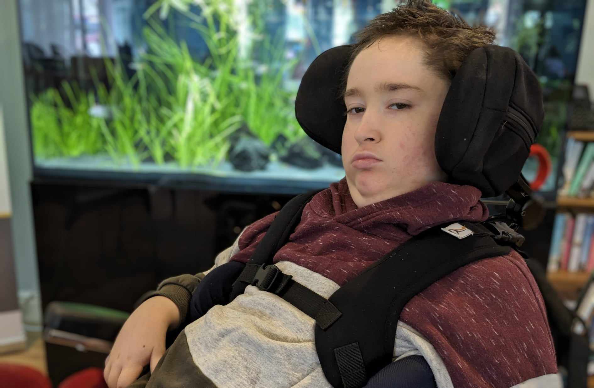 Teen boy in adaptive equipment wheelchair